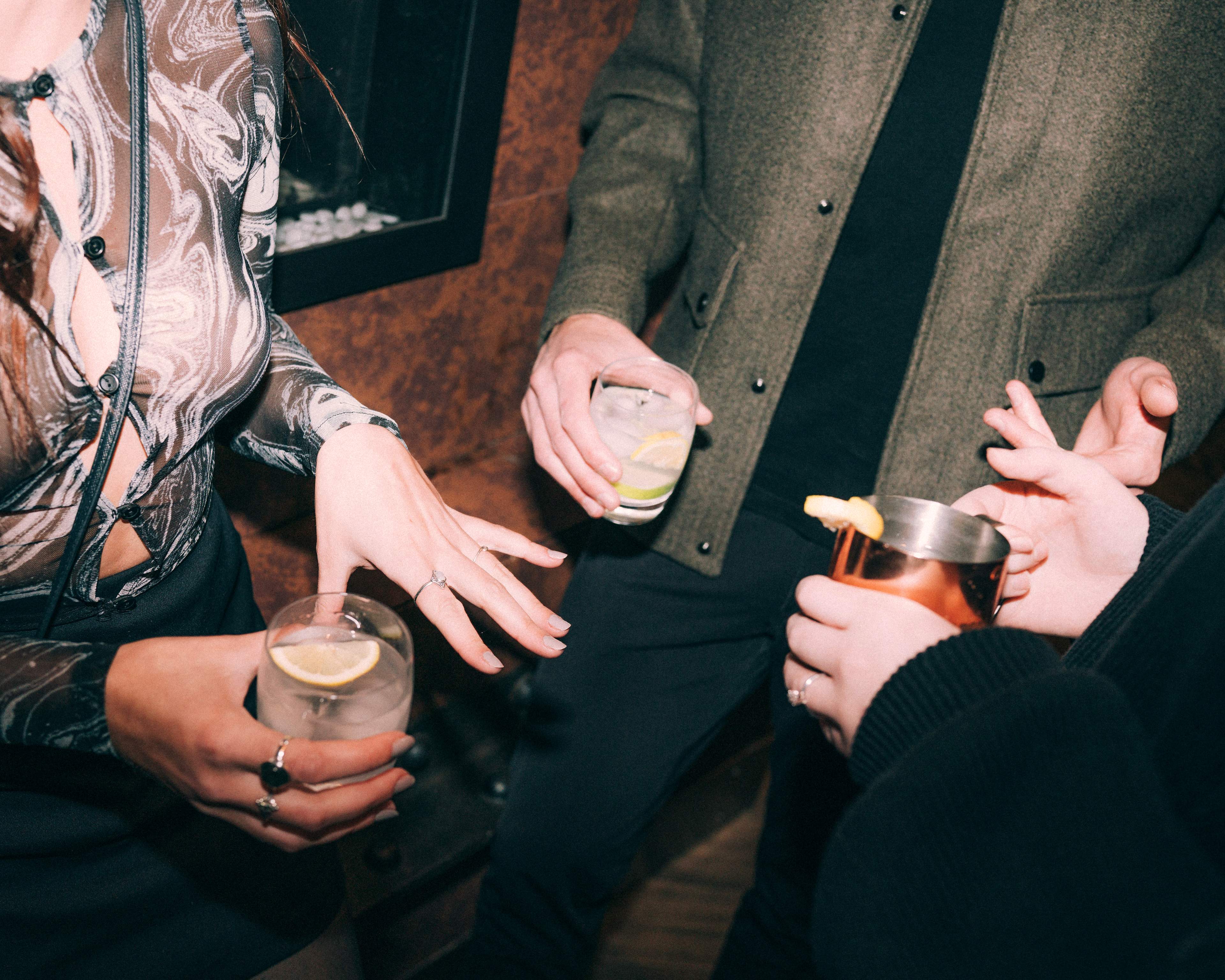 Guests holding cocktails in a lounge setting at MODE by YHA