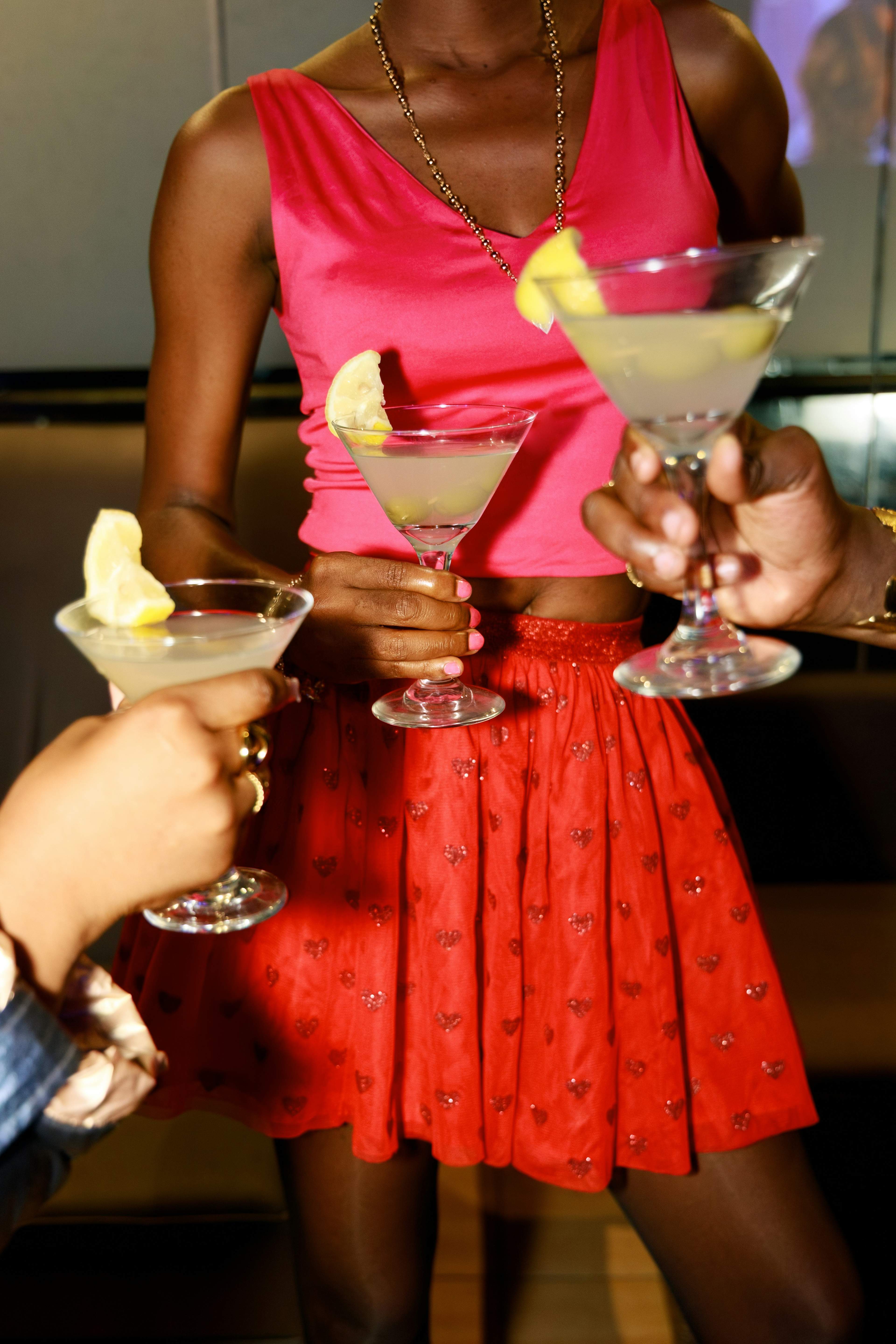Guests toasting cocktails at the MODE Social bar and micro-brewery