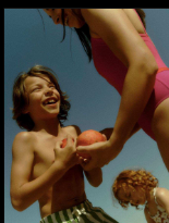 Children laughing and sharing fruit on a sunny summer day