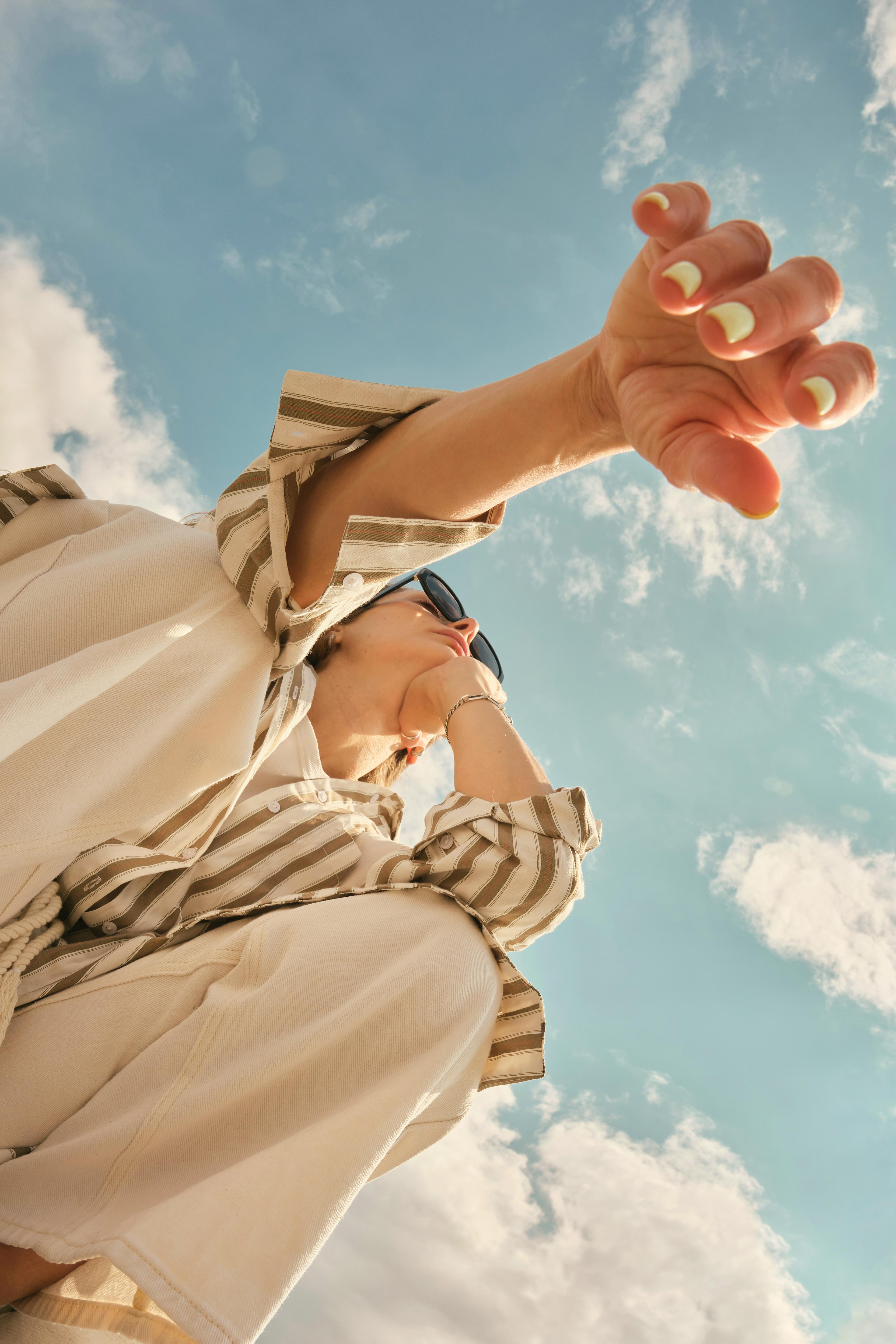 Guest reaching toward the camera against a bright sky at MODE by YHA